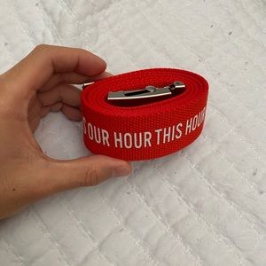 red and white super long h&m belt that reads “this hour is our hour”
